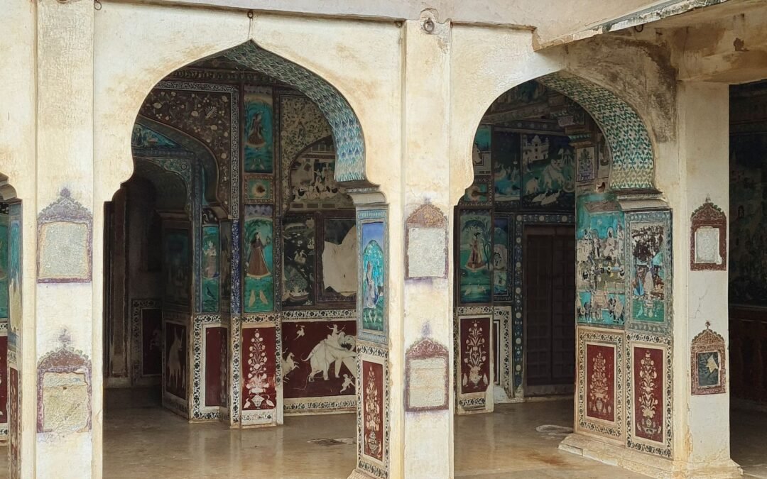 Intricate murals on palace arches in Bundi, India showcasing traditional art and architecture.