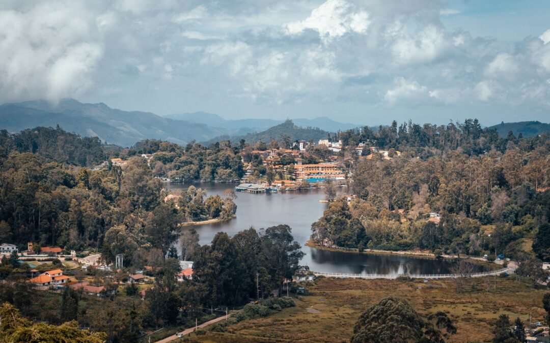 A beautiful aerial shot of Kodaikanal's lush landscape and serene lake surrounded by mountains.