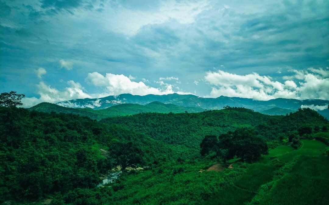 Scenic aerial view of green hills and cloudy sky in Araku Valley, ideal for nature and travel imagery.