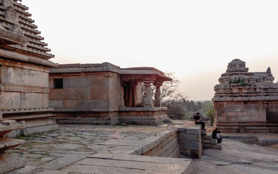Explore the historical architecture of Hampi's ancient temples in Karnataka, India at sunset.