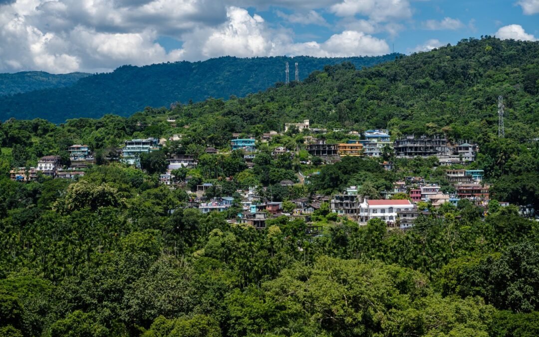 A captivating aerial view of Dawki town nestled in lush greenery and hills, Meghalaya, India.